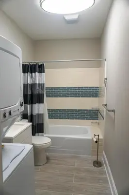a bathroom with a tub and a toilet and a sink at Lincoln Manor - Newly Renovated, 1mile from PHL Airport and Sports Stadiums in Prospect Park