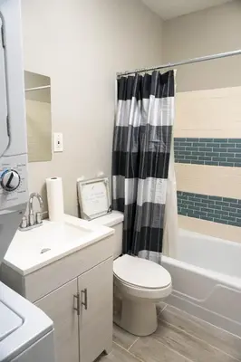 a bathroom with a toilet and a sink and a shower at Lincoln Manor - Newly Renovated, 1mile from PHL Airport and Sports Stadiums in Prospect Park