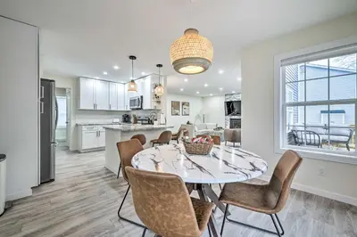 a kitchen and dining room with a table and chairs at Community Beach and Lake Pocono Summit Escape in Pocono Summit