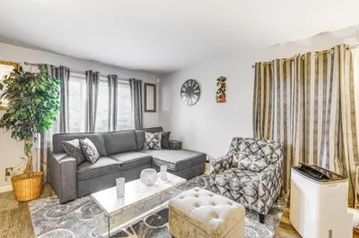 a living room with a couch and a chair at Newark Home with Deck and Fire Pit, 16 Mi to NYC! in Newark