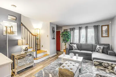 a living room with a couch and a table at Newark Home with Deck and Fire Pit, 16 Mi to NYC! in Newark