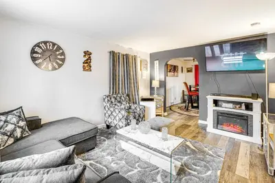 a living room with a couch and a fireplace at Newark Home with Deck and Fire Pit, 16 Mi to NYC! in Newark
