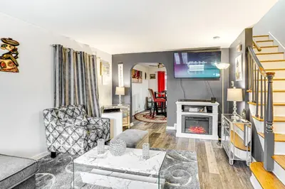 a living room with a couch and a tv at Newark Home with Deck and Fire Pit, 16 Mi to NYC! in Newark