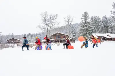 a group of people walking in the snow at Urban Cowboy Lodge in Big Indian