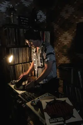 a man standing over a stove in a room at Urban Cowboy Lodge in Big Indian