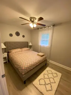 a bedroom with a bed and a ceiling fan at Modern Home near Lake w HotTub, Game Room, Fireplace in Albrightsville