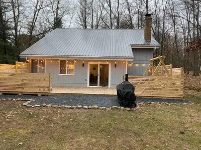 a small house with a playground in front of it at Modern Home near Lake w HotTub, Game Room, Fireplace in Albrightsville