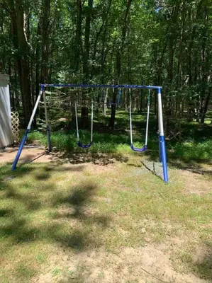 a swing set in a park with trees at Modern Home near Lake w HotTub, Game Room, Fireplace in Albrightsville