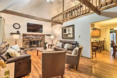 a living room with leather furniture and a fireplace at Near Big Boulder Mtn Cabin with Furnished Deck in Albrightsville