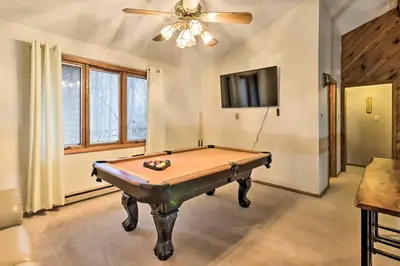 a pool table in a room with a ceiling fan at Near Big Boulder Mtn Cabin with Furnished Deck in Albrightsville