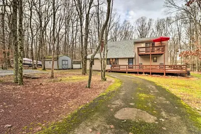 a house with a wrap around porch and a driveway at Near Big Boulder Mtn Cabin with Furnished Deck in Albrightsville