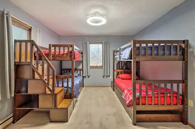 a room with three bunk beds in a house at Near Big Boulder Mtn Cabin with Furnished Deck in Albrightsville