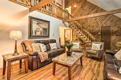 a living room with a couch and a staircase at Near Big Boulder Mtn Cabin with Furnished Deck in Albrightsville