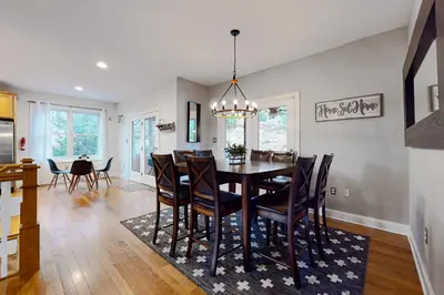 a dining room with a table and chairs at 6 Fieldstone Ct in Lake Harmony