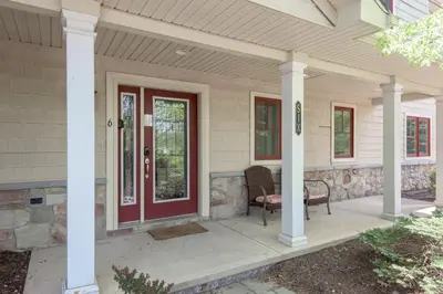 a front porch of a house with a red door at 6 Fieldstone Ct in Lake Harmony