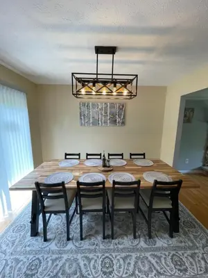 a dining room with a table and eight chairs at Spacious Pocono Home with Hot Tub and Fire Pit in Long Pond