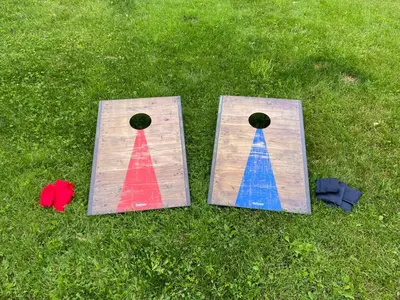 two pieces of wood with colored paint on the grass at Spacious Pocono Home with Hot Tub and Fire Pit in Long Pond