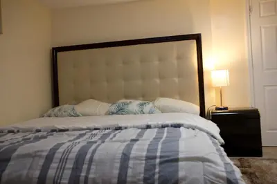 a bedroom with a bed with a large headboard at Mamas Love 2bedroom Spacious Apartment in Newark
