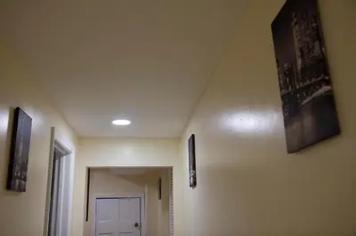 a hallway with pictures on the walls of a room at Mamas Love 2bedroom Spacious Apartment in Newark
