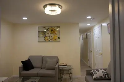 a living room with a couch and a table at Mamas Love 2bedroom Spacious Apartment in Newark