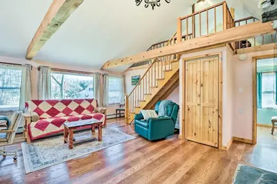 a living room with a staircase and a couch at Cozy Tannersville Gem - Ski, Hike, Explore! in Tannersville