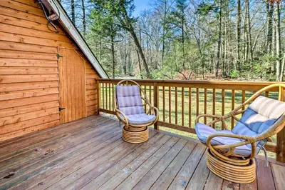 two chairs sitting on the deck of a cabin at Cozy Tannersville Gem - Ski, Hike, Explore! in Tannersville