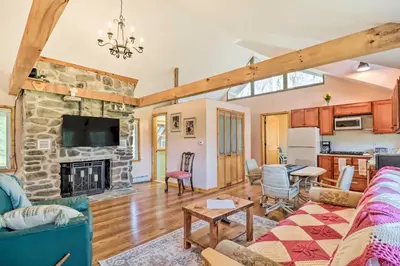 a living room with a couch and a fireplace at Cozy Tannersville Gem - Ski, Hike, Explore! in Tannersville