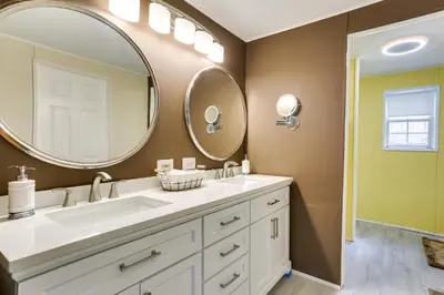 a bathroom with a sink and a large mirror at Kayaks, Electric Bicycles Greentown Hideaway! in Greentown