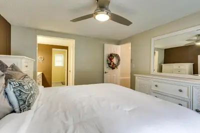 a bedroom with a white bed and a ceiling fan at Kayaks, Electric Bicycles Greentown Hideaway! in Greentown
