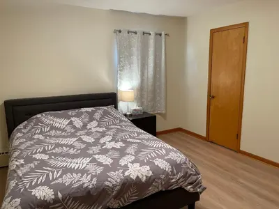 a bedroom with a bed with a black and white comforter at New Brunswick NJ Master Bedroom with private bath in New Brunswick