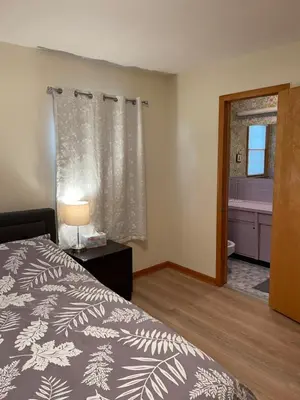 a bedroom with a bed and a bathroom with a tub at New Brunswick NJ Master Bedroom with private bath in New Brunswick
