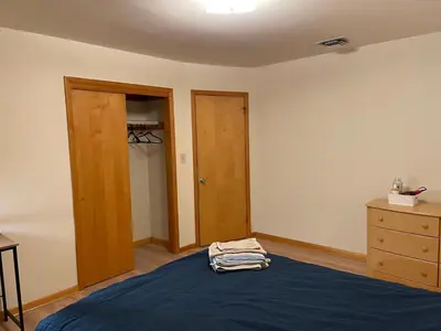 a bedroom with a blue bed and a dresser at #3 QueenSize Bed bright room near New Brunswick NJ downtown in New Brunswick
