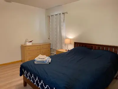 a bedroom with a blue bed with a dresser and a window at #3 QueenSize Bed bright room near New Brunswick NJ downtown in New Brunswick