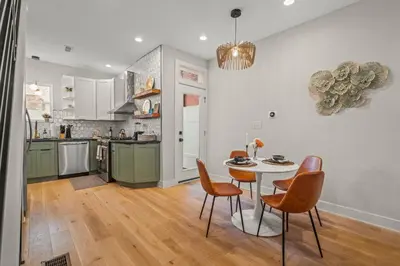 a kitchen and dining room with a table and chairs at Kid-Friendly Fishtown Family Retreat with Game Room in Philadelphia