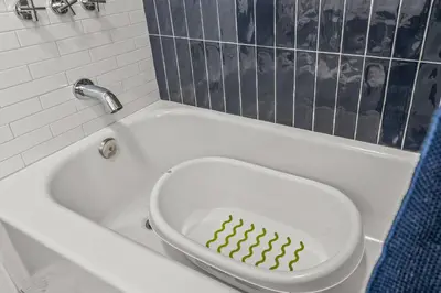 a green christmas tree in a bath tub at Kid-Friendly Fishtown Family Retreat with Game Room in Philadelphia