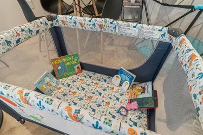 a bed with books and toys on it at Family Fun South Philly Game House Near Sports Stadiums and Concerts in Philadelphia