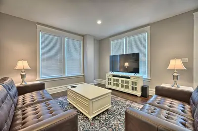 a living room with two couches and a flat screen tv at Suites on Seneca - Lovely 2 Bed 1 Bath Apartment in Harrisburg
