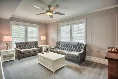 a living room with two couches and a ceiling fan at Suites on Seneca - Beautiful 1 Bedroom Apartment in Harrisburg