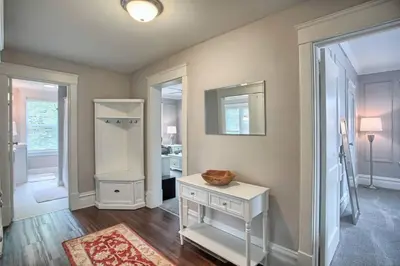 a room with a white table and a mirror at Suites on Seneca - Beautiful 1 Bedroom Apartment in Harrisburg
