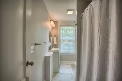 a bathroom with a shower and a sink and a window at Suites on Seneca - Beautiful 1 Bedroom Apartment in Harrisburg