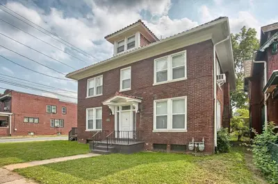 a brick house with a white door at Suites on Seneca - Beautiful 1 Bedroom Apartment in Harrisburg
