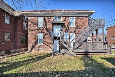 a house with a staircase in front of a building at Suites on Seneca - Beautiful 1 Bedroom Apartment in Harrisburg