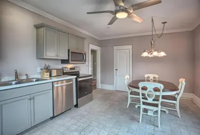 a kitchen with a table and chairs and a ceiling fan at Suites on Seneca - Beautiful 1 Bedroom Apartment in Harrisburg