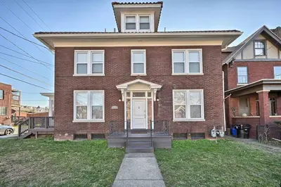 a red brick house with a white door at Suites on Seneca - Gorgeous One Bedroom Apartment in Harrisburg