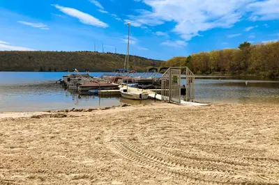 a group of boats docked at a dock on a lake at Midlake Memories in Lake Harmony