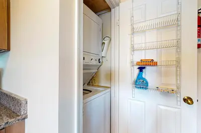 a white kitchen with a blue bottle in the refrigerator at Midlake Memories in Lake Harmony