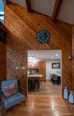 a living room with a clock on a wooden ceiling at Charming Corner Newly Furnished Townhome in Lake Harmony