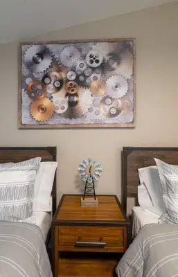 a bedroom with two beds and a table with a clock on it at Charming Corner Newly Furnished Townhome in Lake Harmony