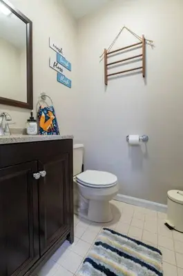 a bathroom with a toilet and a sink and a mirror at Charming Corner Newly Furnished Townhome in Lake Harmony