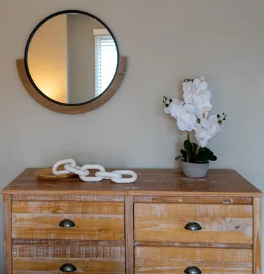 a wooden dresser with a mirror on a wall at Charming Corner Newly Furnished Townhome in Lake Harmony